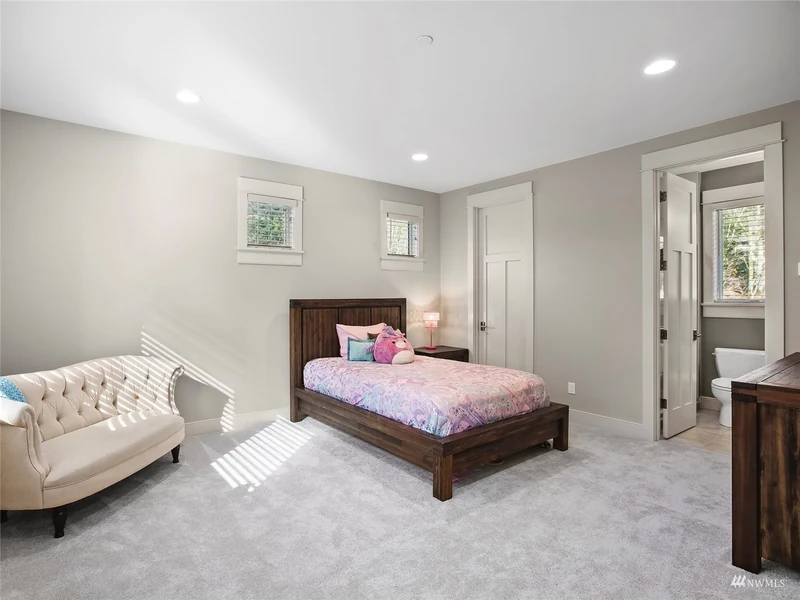 Bedroom with a sloped ceiling, twin beds and a sitting area