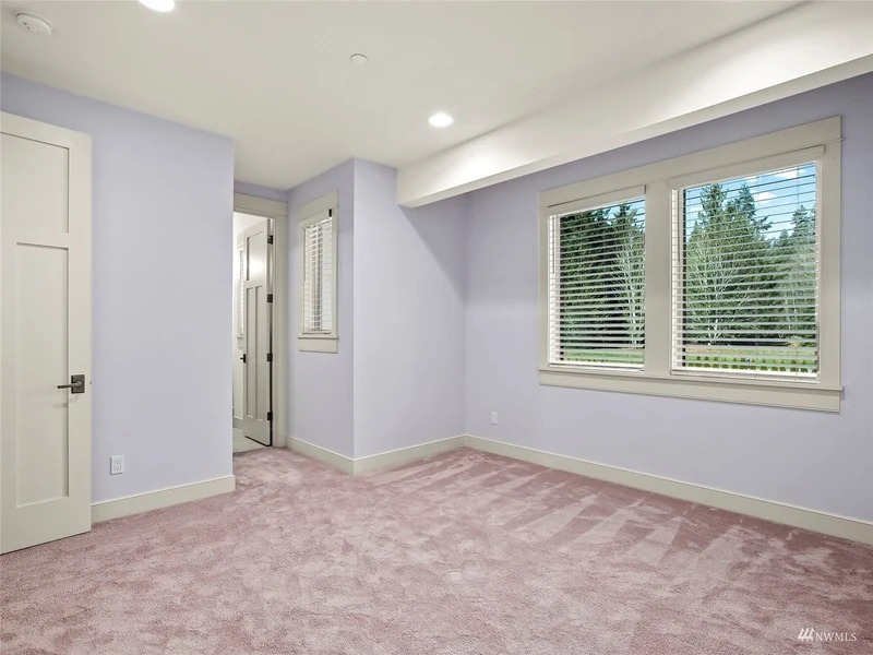 Bedroom with a fitted closet and broad windows