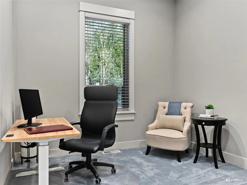 Home office with a desk and tall window