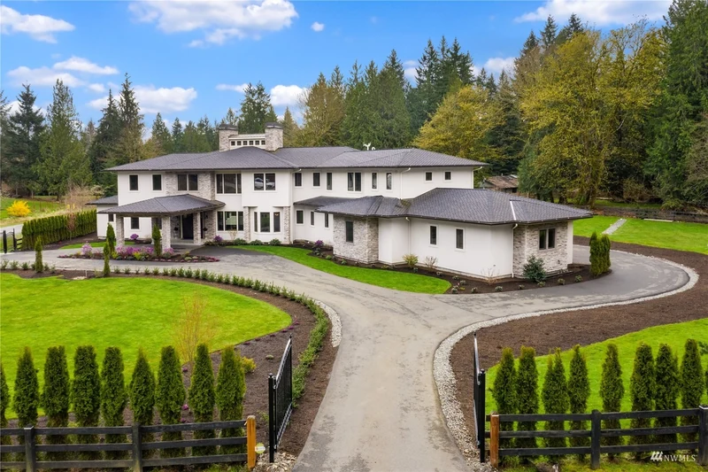 Daytime view of the Woodinville home and curved front drive