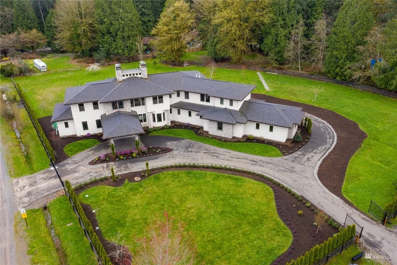 Aerial view of the home, curved driveway and surrounding grounds