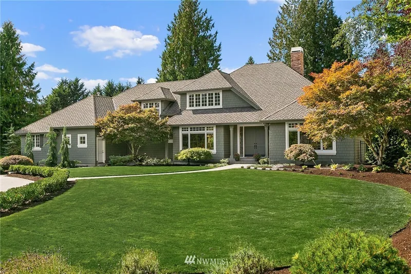 Front exterior of a Woodinville home behind a broad green lawn
