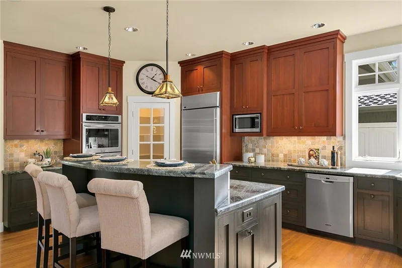 Kitchen with wood cabinetry and a contrasting island