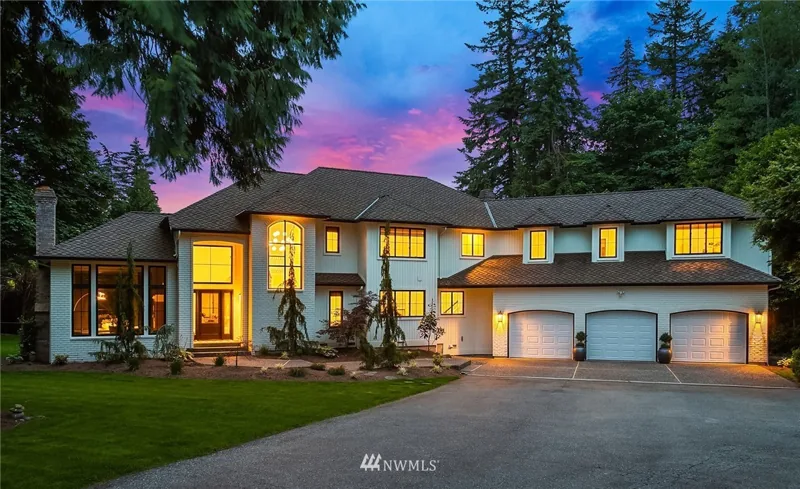 Two-story Woodinville home beneath a colorful evening sky