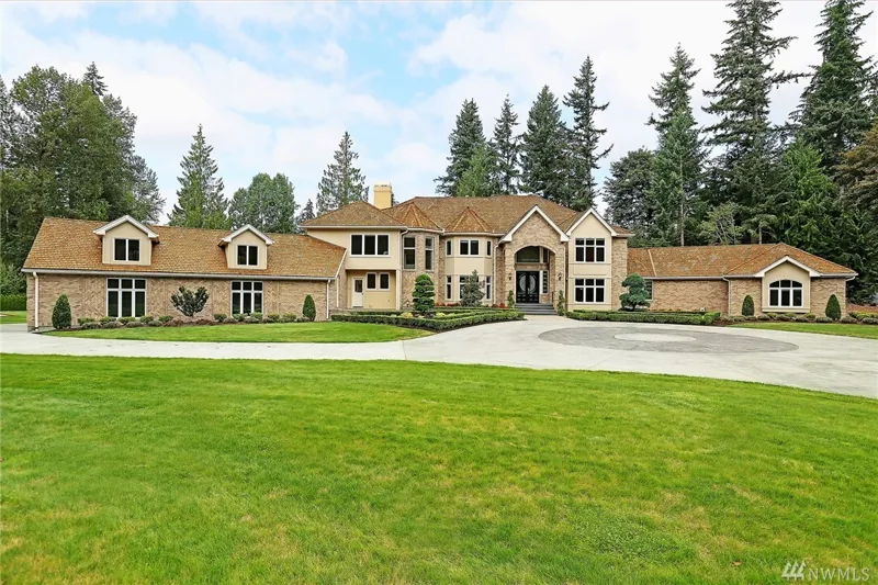 Woodinville home with gabled wings overlooking a front lawn