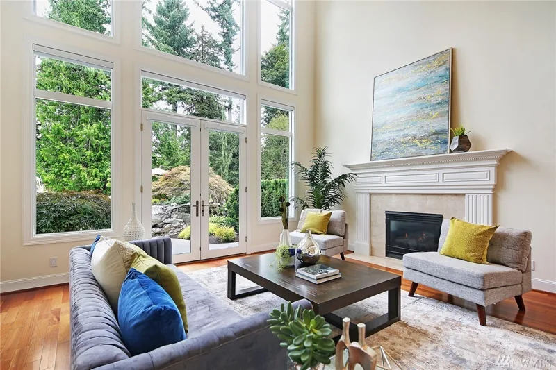 Living room with tall windows and a fireplace
