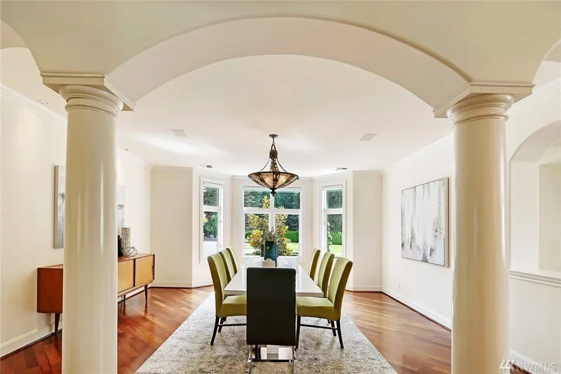 Dining room framed by columns and a broad archway