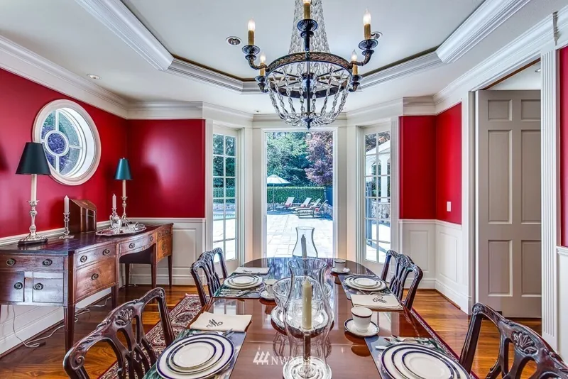 Dining room with red walls and a chandelier