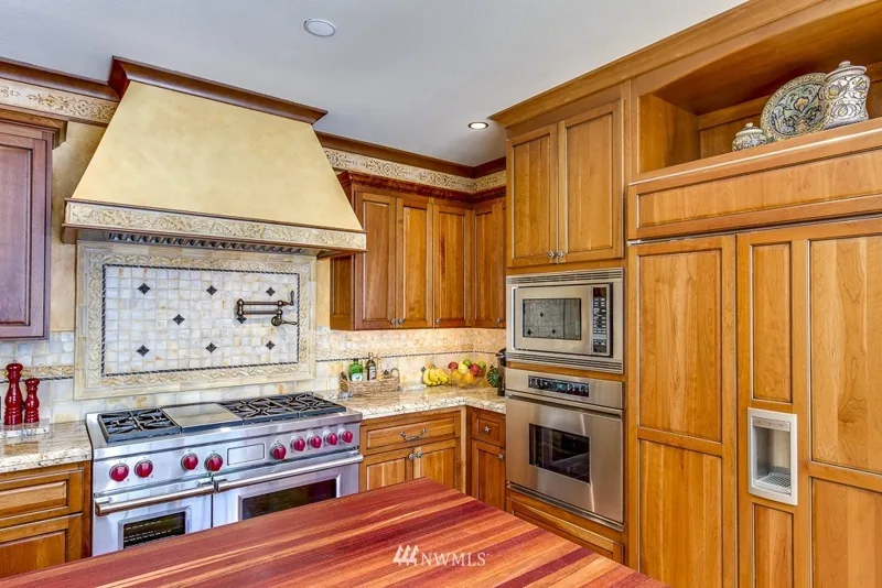 Kitchen with wood cabinetry and a decorative tile backsplash