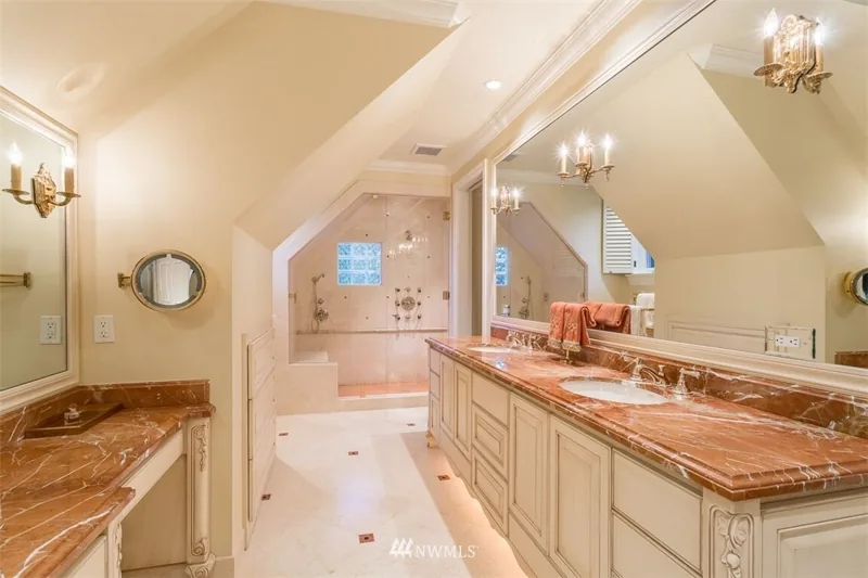 Bathroom with long vanities beneath a vaulted ceiling