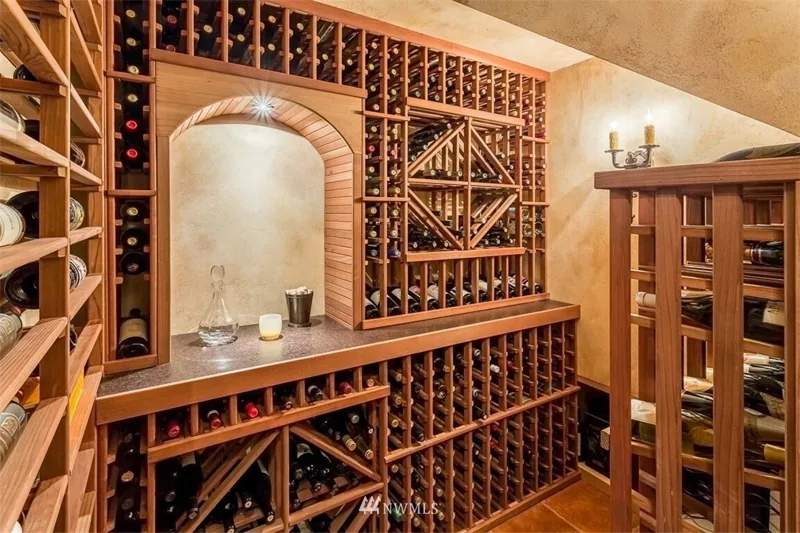 Wine room with wood bottle racks and an arched display niche