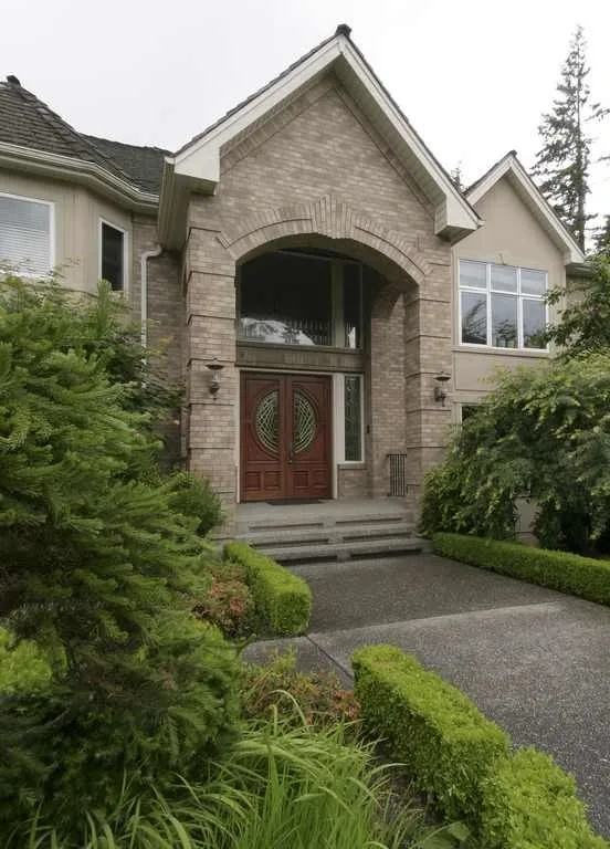 Woodinville, wine room and pool: Closer exterior view of the arched front entry