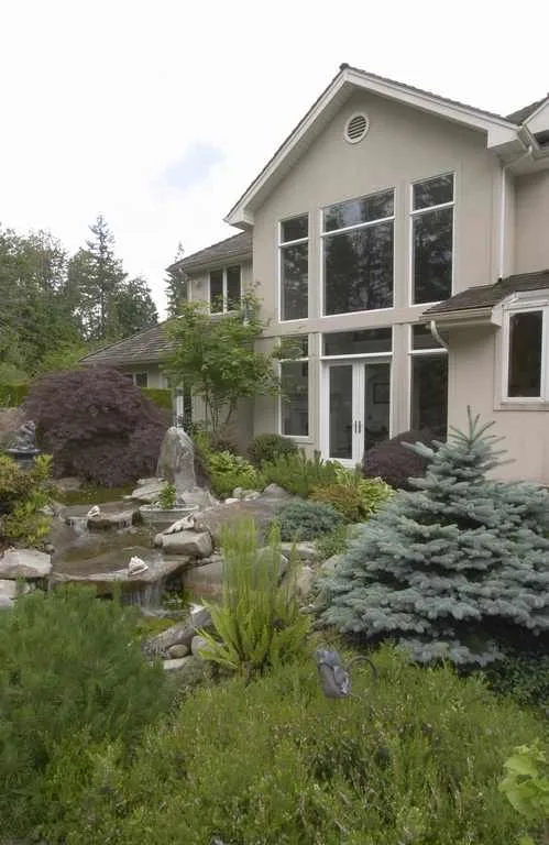 Woodinville, wine room and pool: Rear exterior beside landscaped rockwork and planting