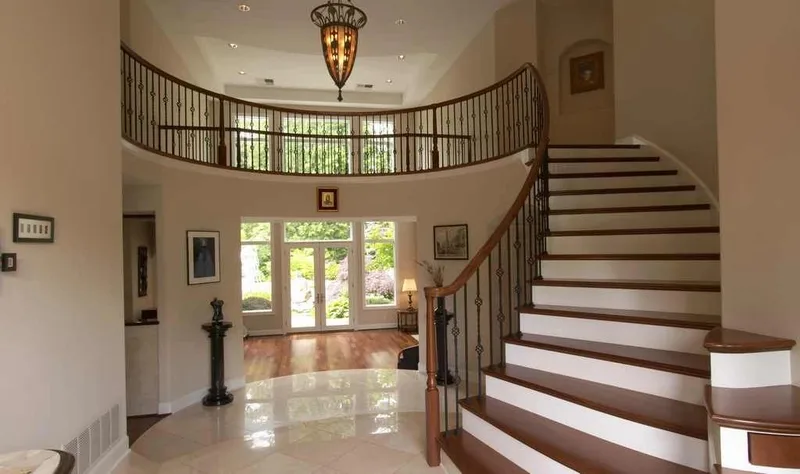 Woodinville, wine room and pool: Entry hall with a curved staircase and upper gallery