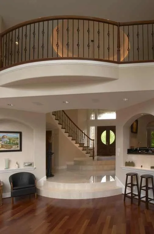 Woodinville, wine room and pool: Tall entry volume and curved upper-level railing