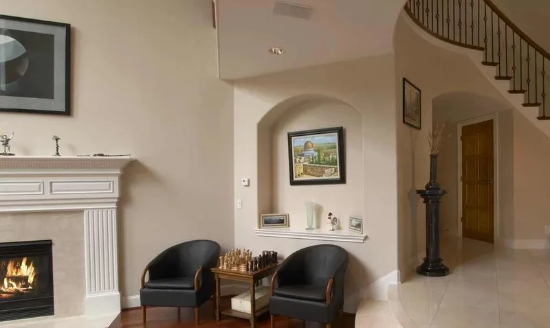 Woodinville, wine room and pool: Front sitting area with a fireplace beside the staircase