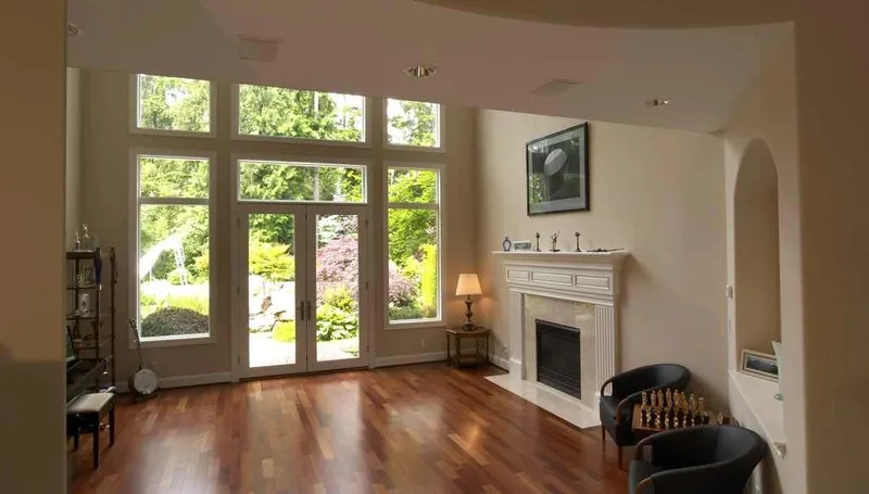 Woodinville, wine room and pool: Sitting room with a fireplace and tall garden-facing windows