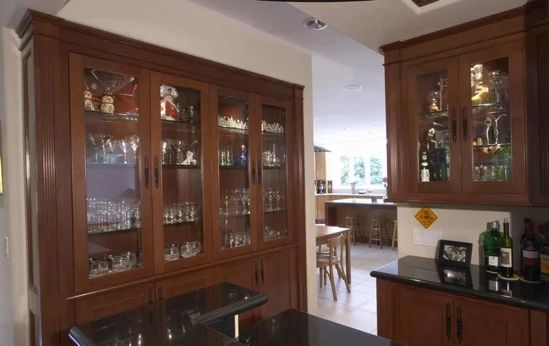 Woodinville, wine room and pool: Glass-front wood cabinetry connecting the dining room and kitchen