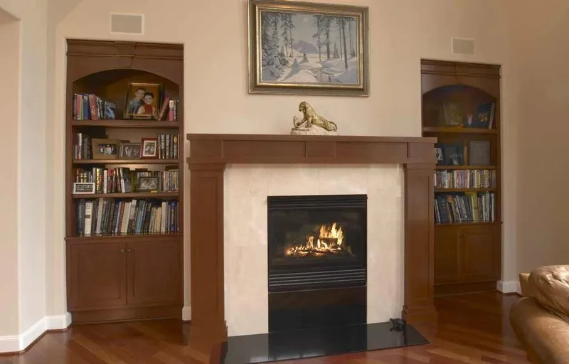 Woodinville, wine room and pool: Family room fireplace framed by wood bookcases