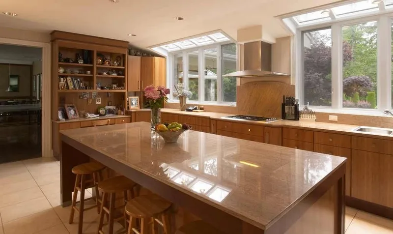 Woodinville, wine room and pool: Kitchen island viewed toward the window-lined counter