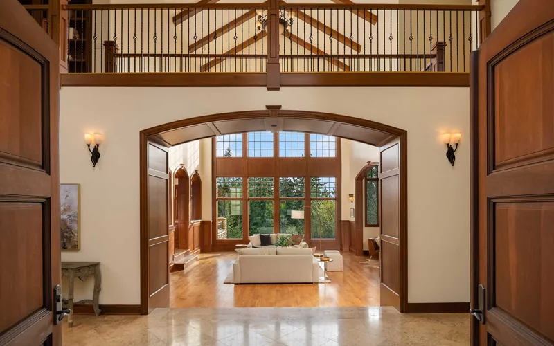 Wood-trimmed entry hall looking toward the double-height living room