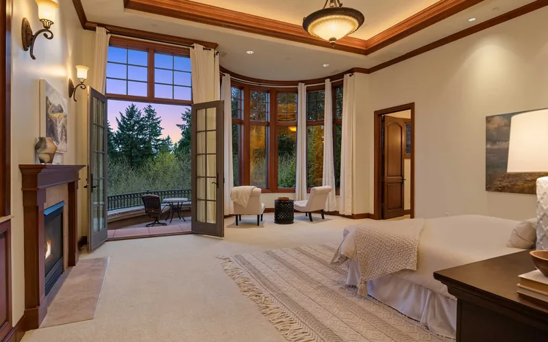 Bedroom with tall windows and balcony doors