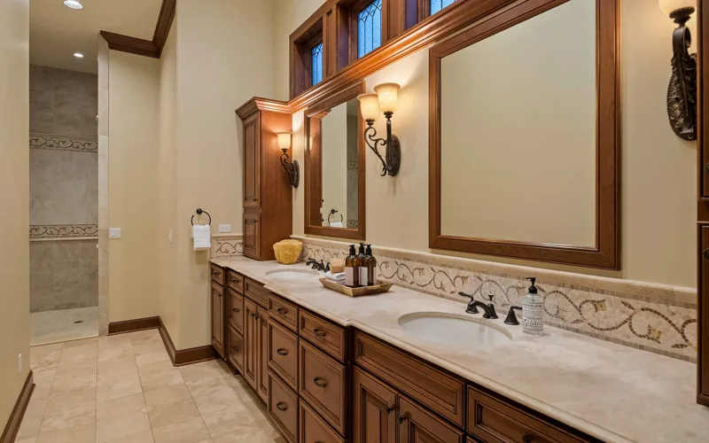 Bathroom with a long wood vanity and paired sinks